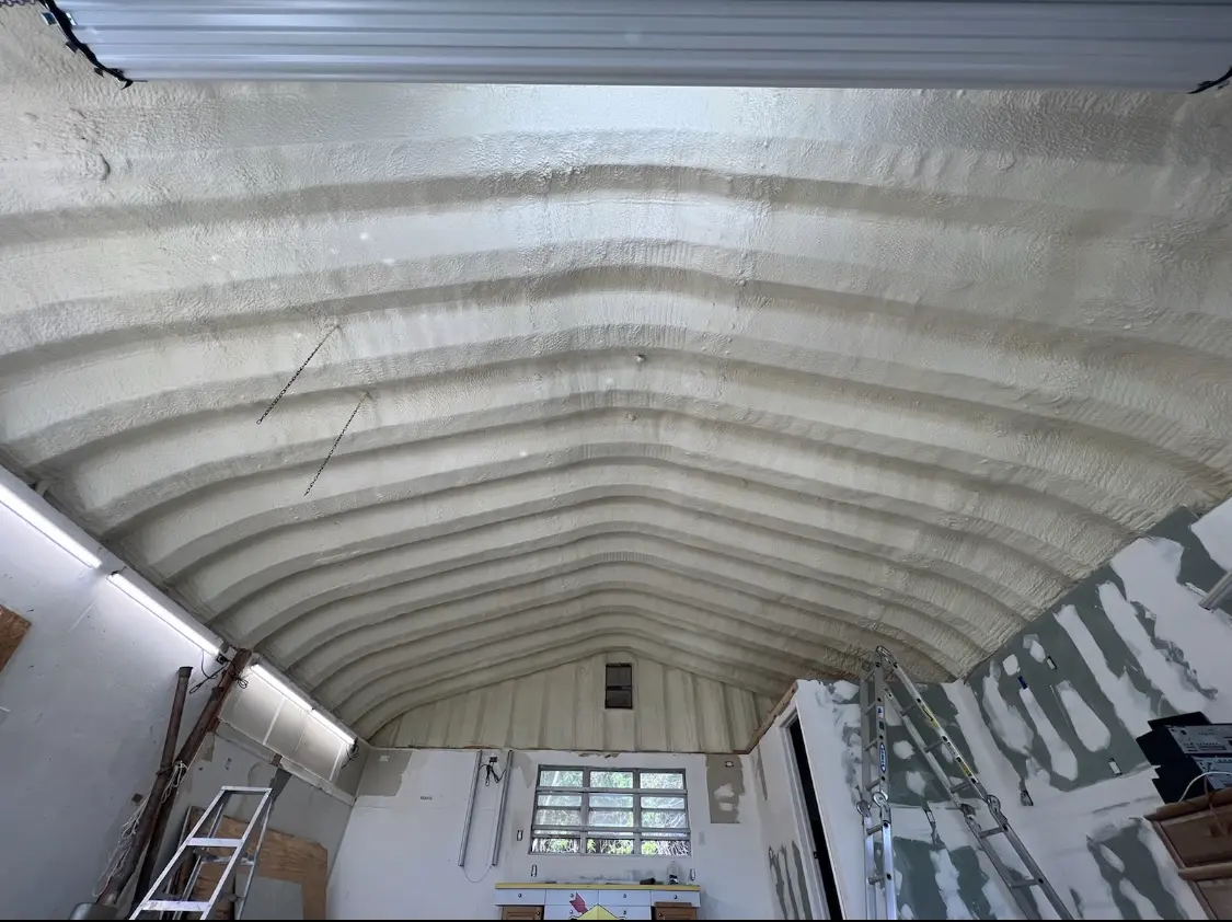 Spray polyurethane foam applied to the underside of a metal roof deck in Martinsville
